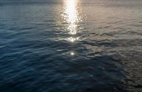 Blurred ocean background with reflections and bokeh Stock Photos