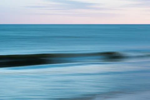 Blurred ocean waves at twilight. Stock Photos