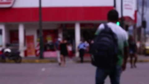 A blurred or defocused view from unrecognisable people crossing the street Stock Footage 153721232