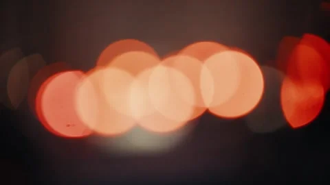Blurred orange lights creating bokeh effect in dark environment Stock Footage 305356533