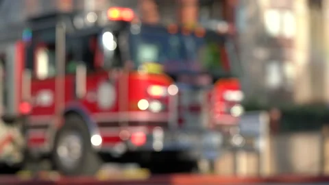 Blurred out firetruck with the emergency lights on at a fire scene. Stock Footage