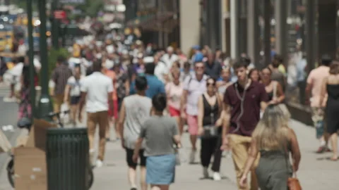 Blurred, out of focus slow motion shot of crowd of people walking on a sidewalk. Stock Footage 142604920