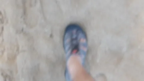 Blurred out of focus top down to footed feet while walking on sandy white o.. Stock Footage 286314389