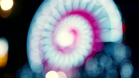 A blurred out view of a ferris wheel attraction at night in amusement park Stock Footage 186185283