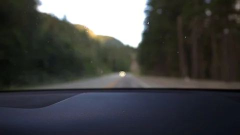 A blurred out view from the interior of a car of a mountain forest highway with Stock Footage 111448504