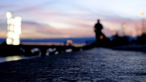 Blurred:  People jogging next to river Tejo/Tagus in sunset Stock Footage 129973989