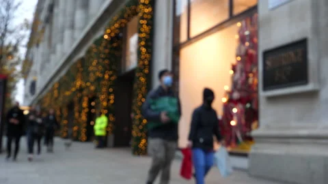 Blurred people passing store front Christmas decorations 動画素材 144438030