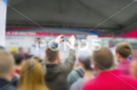 Blurred People Raised Hands with Smartphones Recording the Event. Stock Photos