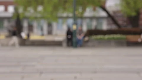 Blurred People Walking in Slow Motion with Green Trees in Background (4K) Stock Footage 309461002