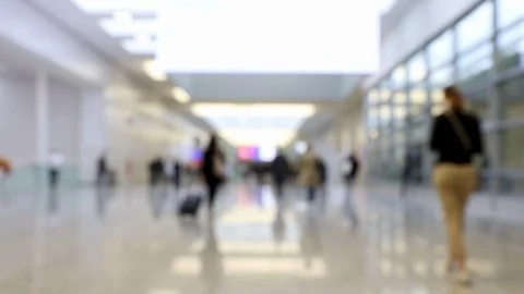 Blurred people walking through shot in a convention hallway Stock Footage 123835224