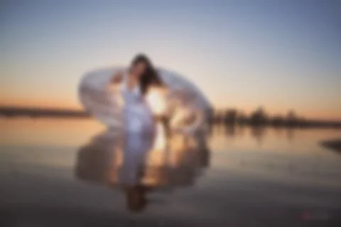 Blurred picture for background, Angel at sunset, wings by the sea, a good ide Fotos Stock
