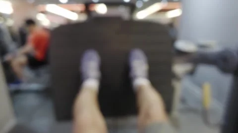 Blurred point of view shot of a person using a leg press machine at the gym.. Stock Footage 343114367