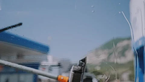 Blurred POV Shot from Inside Car Washing Windshield with Squeegee Tool. 動画素材 338238214