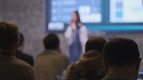 Blurred presentation setting with audience focus highlighting public speaking Stock Footage 301696142
