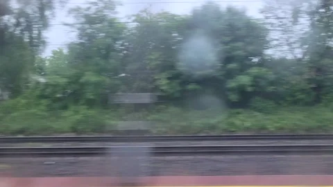 Blurred railway view through a rainy train window 스톡 동영상 336741799