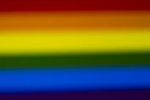 Blurred rainbow flag colors represent diversity and inclusivity. The vibrant Stock Illustration