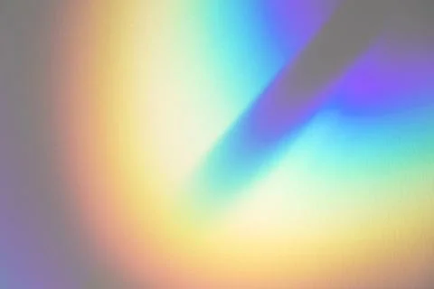Blurred rainbow light refraction texture on white wall Stock Photos