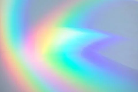 Blurred rainbow light refraction texture on white wall Stock Photos