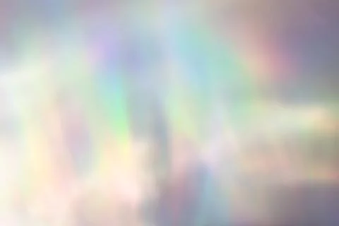 Blurred rainbow light refraction texture on white wall Stock Photos