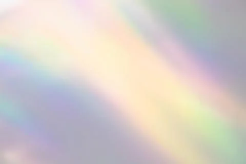 Blurred rainbow light refraction texture on white wall Stock Photos