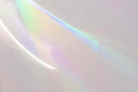 Blurred rainbow light refraction texture on white wall Stock Photos