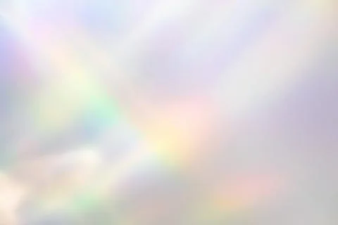 Blurred rainbow light refraction texture on white wall Stock Photos
