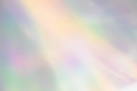 Blurred rainbow light refraction texture on white wall Stock Photos