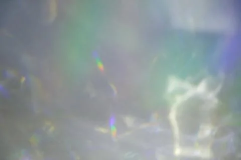 Blurred rainbow light refraction texture on white wall Stock Photos