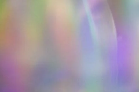 Blurred rainbow light refraction texture on white wall Stock Photos