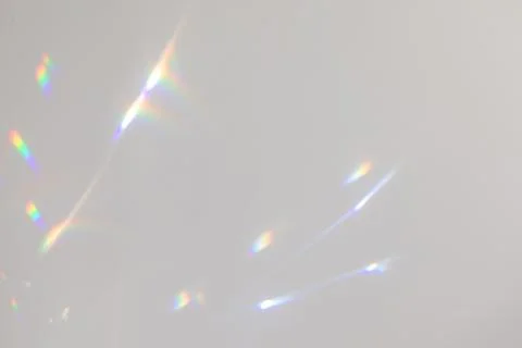 Blurred rainbow light refraction texture on white wall Stock Photos