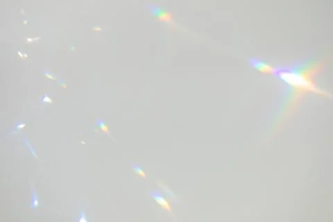 Blurred rainbow light refraction texture on white wall Stock Photos