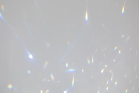 Blurred rainbow light refraction texture on white wall Stock Photos