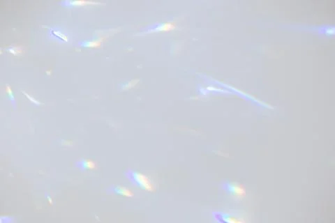 Blurred rainbow light refraction texture on white wall Stock Photos