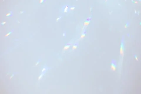 Blurred rainbow light refraction texture on white wall Stock Photos