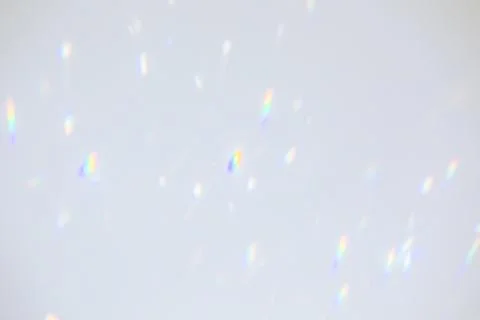 Blurred rainbow light refraction texture on white wall Stock Photos
