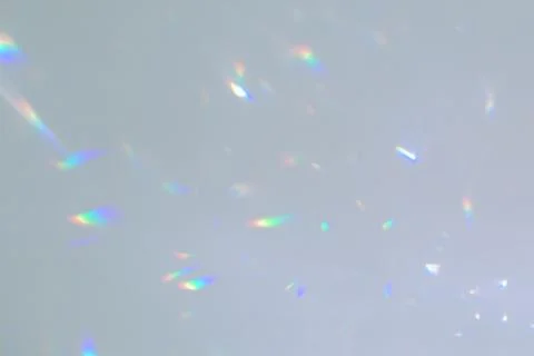 Blurred rainbow light refraction texture on white wall Stock Photos
