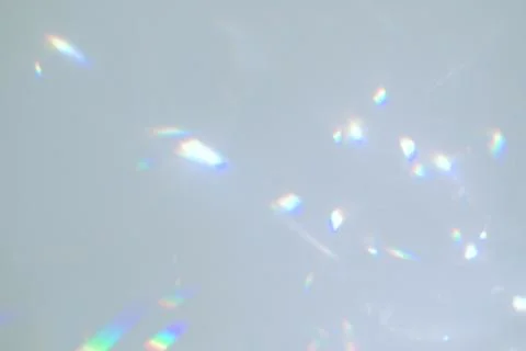 Blurred rainbow light refraction texture on white wall Stock Photos
