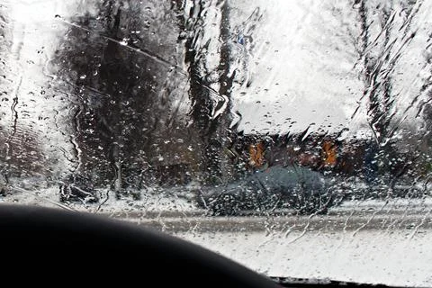 Blurred by raindrops car windshield Stock Photos