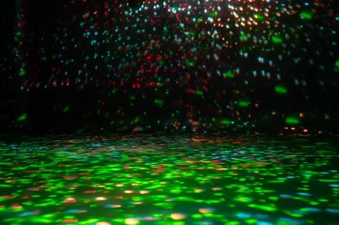 Blurred rays of light on disco floor. red green blue neon searchlight lights. Stock Photos