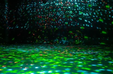 Blurred rays of light on disco floor. red green blue neon searchlight lights. Foto stock