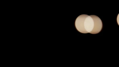 Blurred red and white lights drift across dark background Stock Footage 329816029