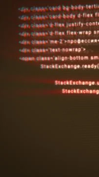 Blurred red-blue distorted code lines displayed on a dark screen, creating a  Illustration