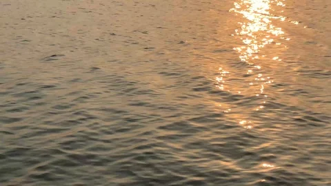 Blurred reflected in the sea sun ray and sunrise over the calm sea Stock Footage