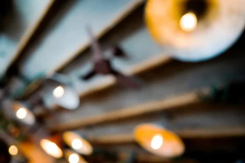 Blurred reflection of the ceiling of a cafe with beautiful lamps in the mirror Stock Photos