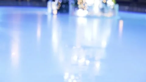 Blurred reflection of garland lights blinking on Christmas tree on ice rink. Stock Footage 144500377