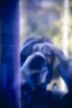 Blurred reflection of photographer with camera Stock Photos