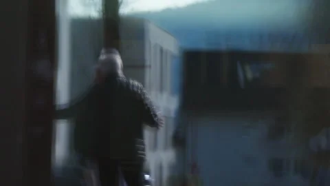 Blurred Reflection of Senior Person Walking in Urban Environment Stock Footage 336221322
