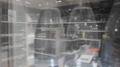 Blurred reflection of a store with alcohol in a glass of a store window. Stock Footage 127396132