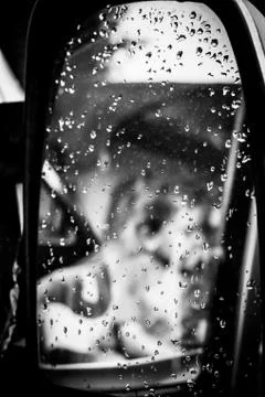 A Blurred Reflection In A Wing Mirror Of Children Pretending To Drive Stock Photos