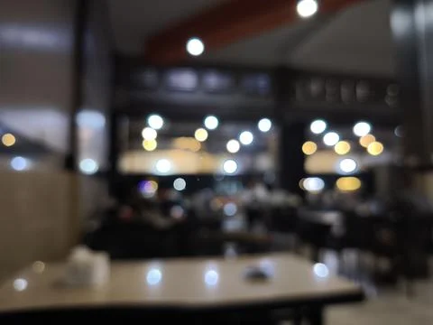 Blurred restaurant interior with dining tables. Stock Photos